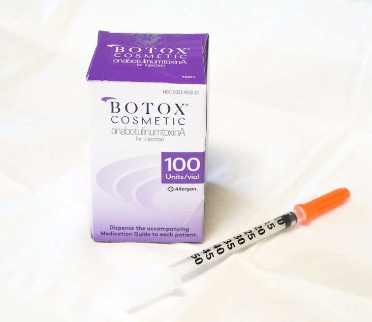 A box of botox with a injecting tool next to it